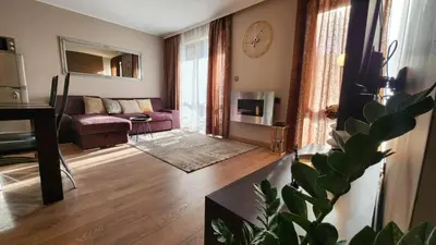 a living room with a couch and a table at SPOMAR One Bedroom Apartment in Bansko