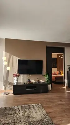 a living room with a flat screen tv and a couch at SPOMAR One Bedroom Apartment in Bansko
