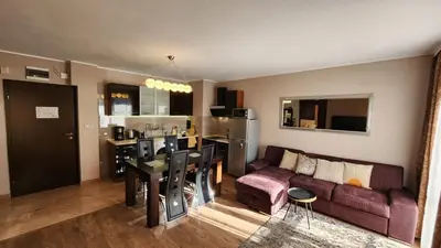 a kitchen and living room with a couch and a table at SPOMAR One Bedroom Apartment in Bansko