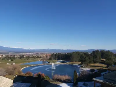 a view of a swimming pool with a fountain at Tranquility Apartment Pirin Golf in Razlog