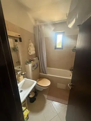 a bathroom with a toilet and a tub and a sink at Tranquility Apartment Pirin Golf in Razlog