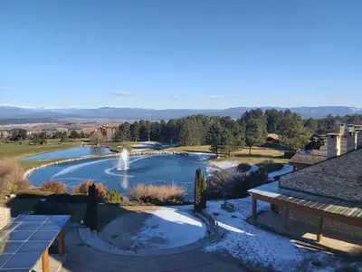 a view of a pool with a fountain in a yard at Tranquility Apartment Pirin Golf in Razlog