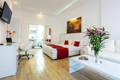 a hotel room with a bed and a couch at Complex Europe in Dolna Banya