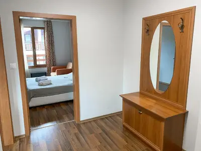 a room with a mirror and a bed and a bedroom at Evergreen Private Apartment 303 in Bansko