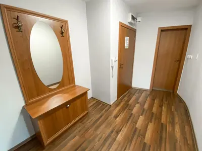 a room with a mirror and a wooden dresser at Evergreen Private Apartment 303 in Bansko