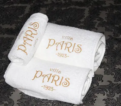 a stack of white towels with the words tilla parks at Villa Paris in Hisarya