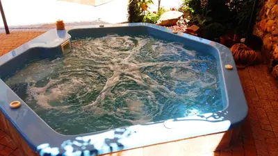 a jacuzzi tub filled with water on a patio at Villa Paris in Hisarya