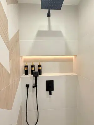 a bathroom with three soap dispensers on a wall at Lux Boutique 2 BDR apartment right next ski gondola lift in Bansko
