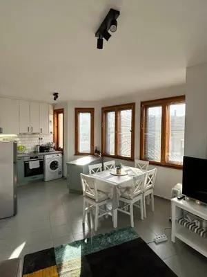 a kitchen with a table and chairs in a room at Cu29 Kapana art Apartments in Plovdiv