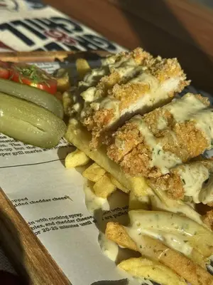 a plate of food with a slice of pizza and fries at Мотел КОМПЛЕКС GRILL and CHILL in Levunovo