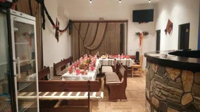 a long dining room with a long table with chairs at Rodopsko Katche in Alamovtsi
