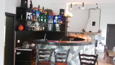 a bar with chairs and a counter in a room at Rodopsko Katche in Alamovtsi