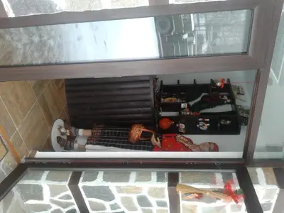 a view through a glass window of a room at Rodopsko Katche in Alamovtsi