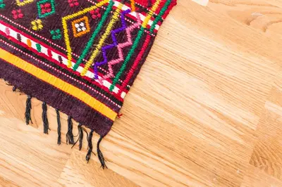 a close up of a rug on a wooden table at Rodopsko Katche in Alamovtsi