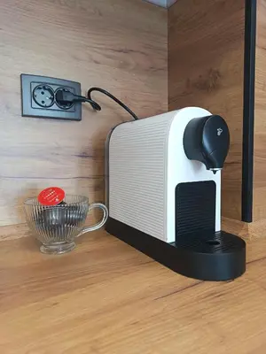 a toaster oven sitting on a table with a bowl at Boutique apartment 4-6 in Plovdiv