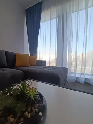 a living room with a couch and a table at Boutique apartment 4-6 in Plovdiv