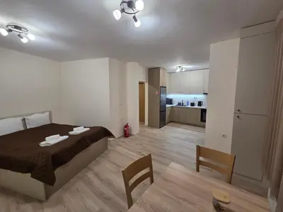a bedroom with a bed and a living room at Apartment Aria 7 in Velingrad