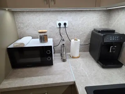 a kitchen with a microwave and a coffee maker on a counter at Apartment Aria 7 in Velingrad