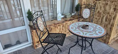 a table and two chairs sitting on a porch at Amore Grande in Beli Iskar
