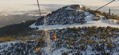 a ski lift going up a snow covered mountain at Amore Grande in Beli Iskar