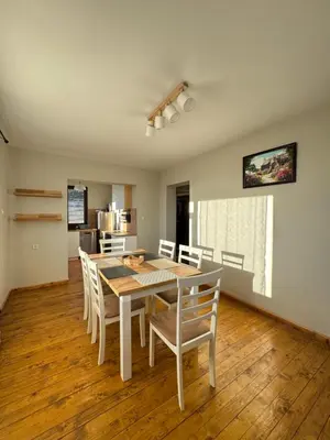 a kitchen and dining room with a table and chairs at Къща за гости Пегас in Velingrad