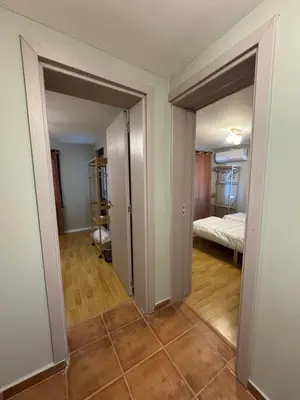 an empty room with two doors and a bedroom at Къща за гости Пегас in Velingrad