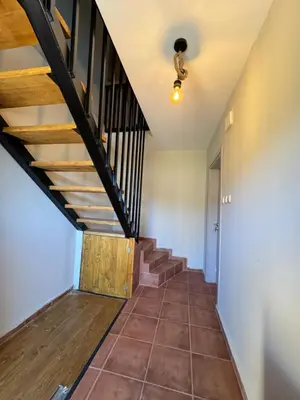 a staircase in a house with wooden stairs and a ceiling at Къща за гости Пегас in Velingrad