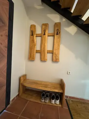 a bench in a room with two pairs of shoes at Къща за гости Пегас in Velingrad