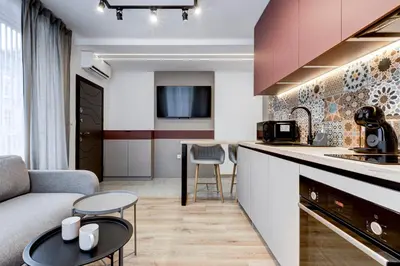 a kitchen and living room with a couch and a table at Newly Renovated Comfortable First-Floor Stay in Sofia