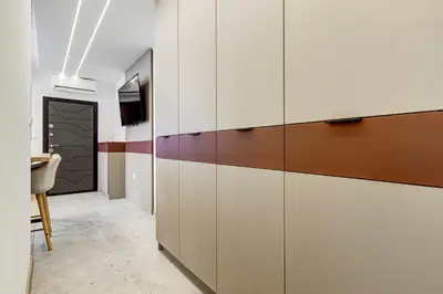 a room with white and brown cabinets and a table at Newly Renovated Comfortable First-Floor Stay in Sofia
