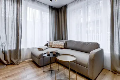 a living room with a couch and a table at Newly Renovated Comfortable First-Floor Stay in Sofia