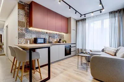 a kitchen and living room with a table and a couch at Newly Renovated Comfortable First-Floor Stay in Sofia