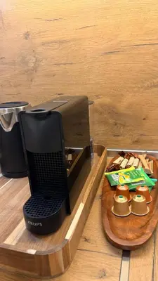 a laptop computer on a wooden tray with a plate of food at Lux Living Apartments in Plovdiv