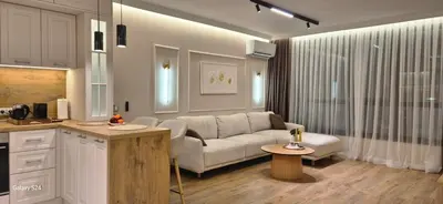 a kitchen and living room with a couch and a table at Lux Living Apartments in Plovdiv