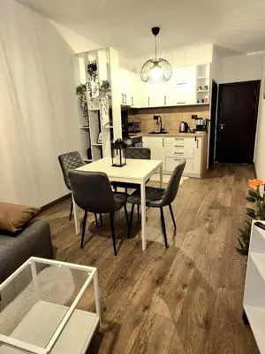 a kitchen and dining room with a table and chairs at Kapana Garden - 4 persons luxury apartment in Plovdiv