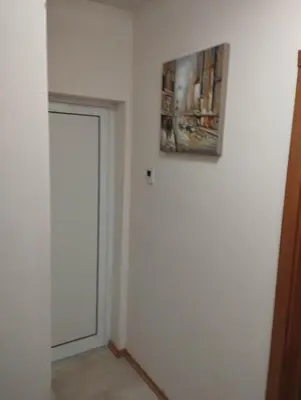 a hallway with a door and a painting on the wall at Bansko View 3 in Bansko