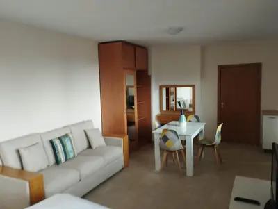 a living room with a couch and a table at Bansko View 3 in Bansko