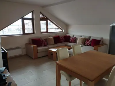 a living room with a couch and a table at Bansko View 3 in Bansko