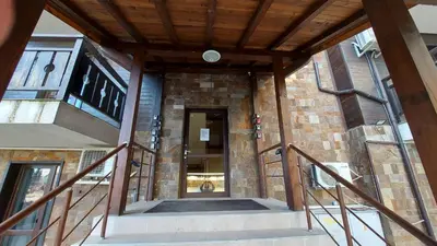a building with a staircase leading to a door at Аpartment C103 Grand Bansko 1 in Bansko