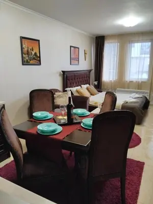 a living room with a table and a couch at Ski point in Pamporovo