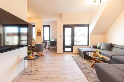 a living room with a couch and a table at Domus Apartments Vista in Plovdiv