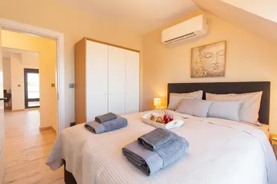 a bedroom with a large bed with two pillows on it at Domus Apartments Vista in Plovdiv