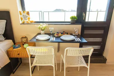 a small room with a table and two chairs at Domus Apartments Vista in Plovdiv