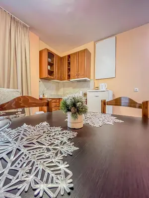 a kitchen and dining room with a table at Fireplace Apartment near Bus & Train Station in Bansko