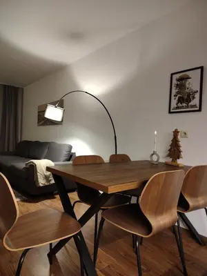 a living room with a table and chairs and a couch at Family Apartment Royal Tower in Bansko