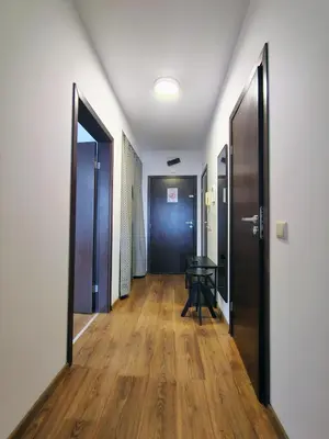 an empty hallway with two doors and a table at Family Apartment Royal Tower in Bansko