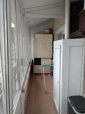 a room with a hallway with a table and a refrigerator at Apartment near Bulgaria Boulevard in Sofia