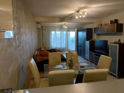 a living room with a table and a couch at Apartment near Bulgaria Boulevard in Sofia