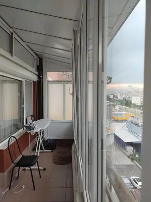 a room with a chair and a desk and a window at Apartment near Bulgaria Boulevard in Sofia