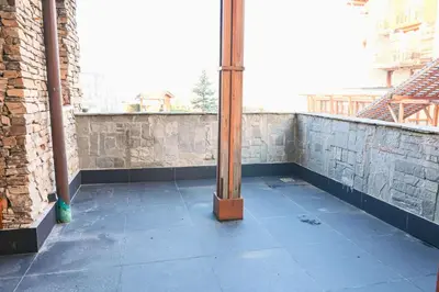 a wooden pole sitting on top of a balcony at Cozy 1-Bedroom Apartment in St Ivan Ski Resort by Flat Mаnаger in Blagoevgrad